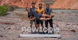 After pitching investors, 4 founders stand in the desert in front of VC newtopia sign